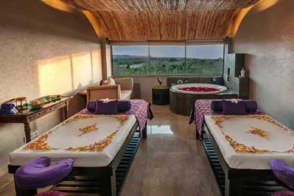Ayana Resort and Spa couples spa Bali experiences, showing a romantic massage setup with ocean views.