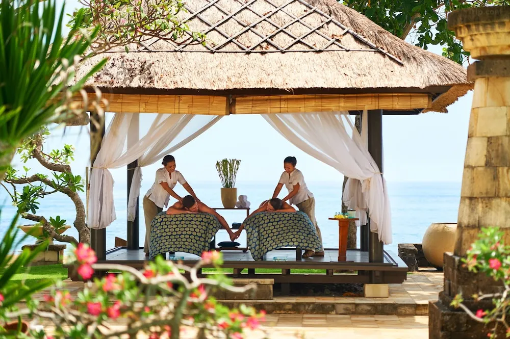 Choosing among the myriad of Bali hotels with spa services can be overwhelming, depicting a person looking at various hotel options on a tablet.