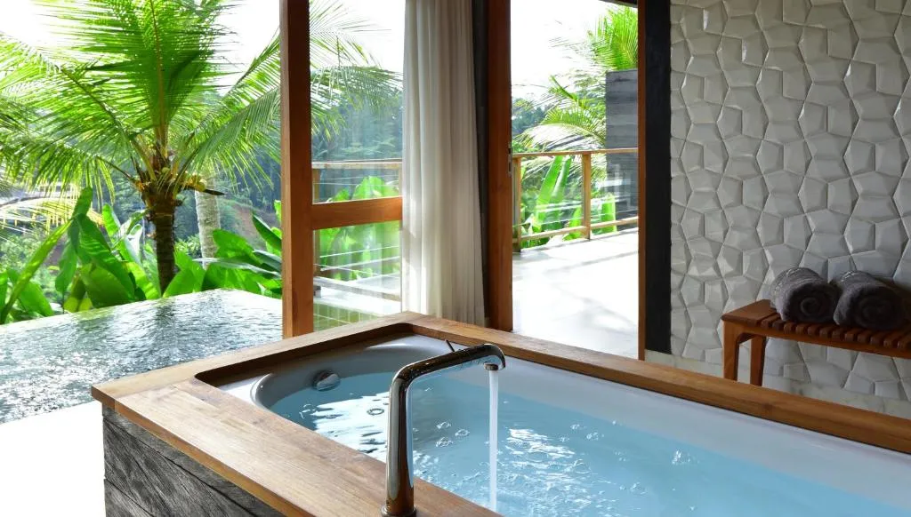 A stunning view of Chapung Sebali Resort in Ubud, highlighting its unique design, possibly an infinity pool, or its integration with the lush jungle and rice paddies of Bali.