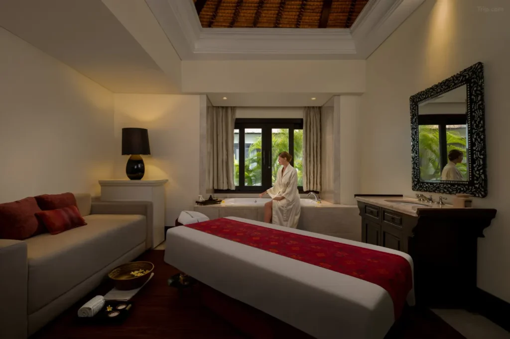 The Trans Resort Bali: A large, modern pool area with sandy beach access.